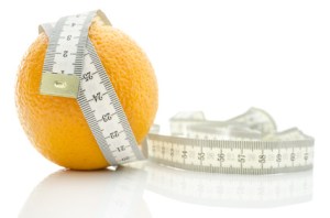 Orange fruit wrapped with measuring tape